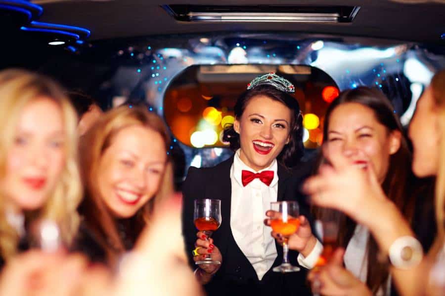 Group Of Happy Elegant Women Clinking Glasses In Limousine, Hen Party